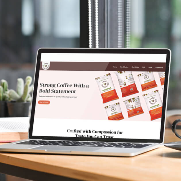 A laptop displays a Cafe Delicioso’s website, featuring product packaging and text, with a cup of coffee on a table alongside cacti.