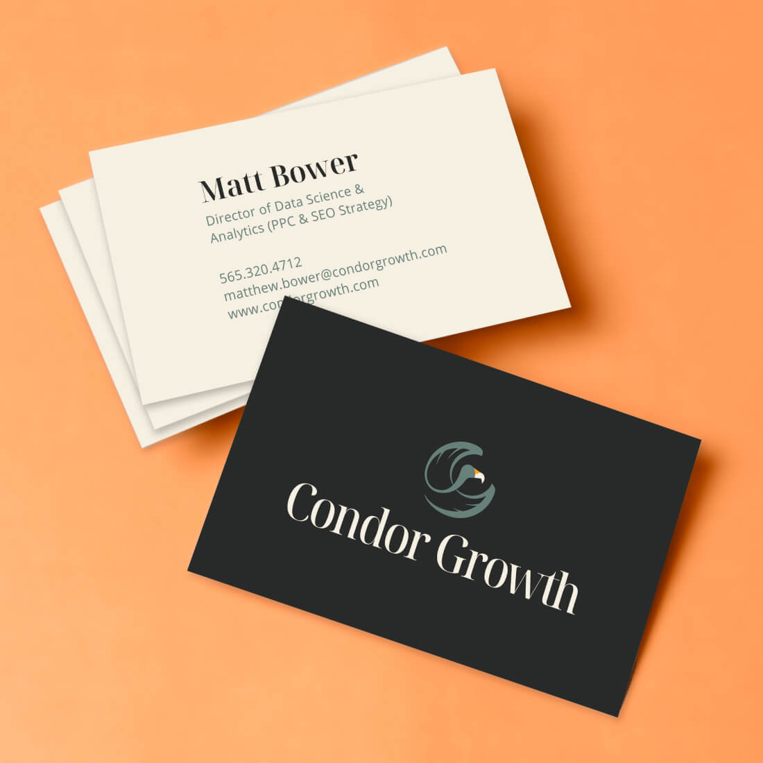 Two business cards for Condor Growth with an orange background. The front is a logo on black ground, and back is white with name and information on white.