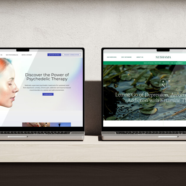 Two laptops on a light wooden table display, with two different websites for Nushama.